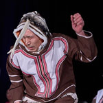 Inuk dancer performing onstage.