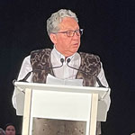 Minister Vandal standing behind the custom built podium made in the shape of a qamutik (traditional Inuit Sled).